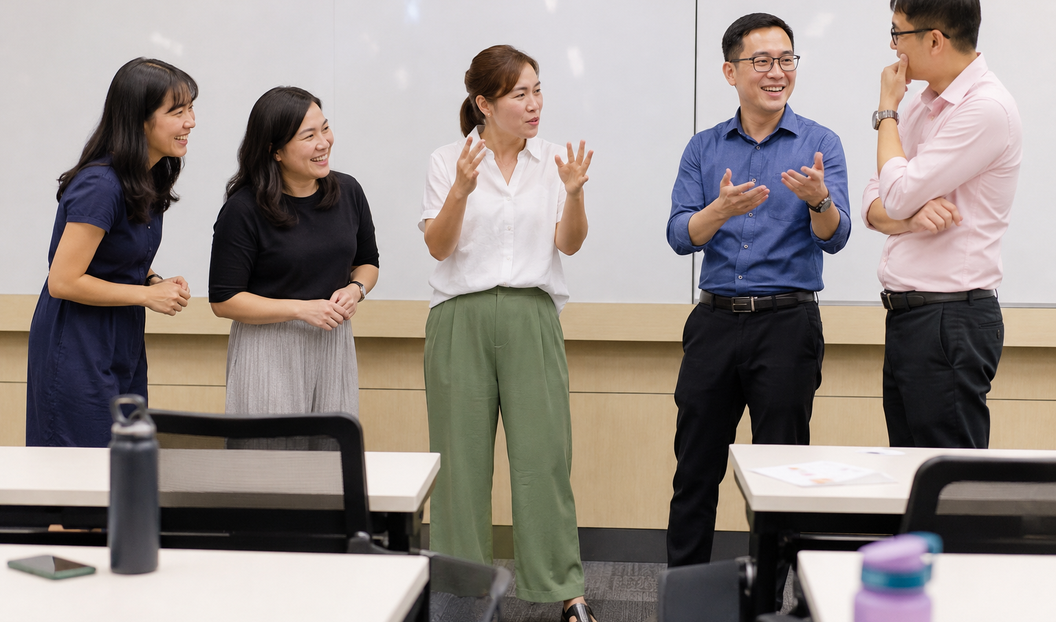5 Singapore teachers role playing in the front of a classroom